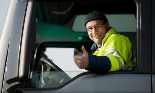 Commercial truck driver giving a thumbs up.